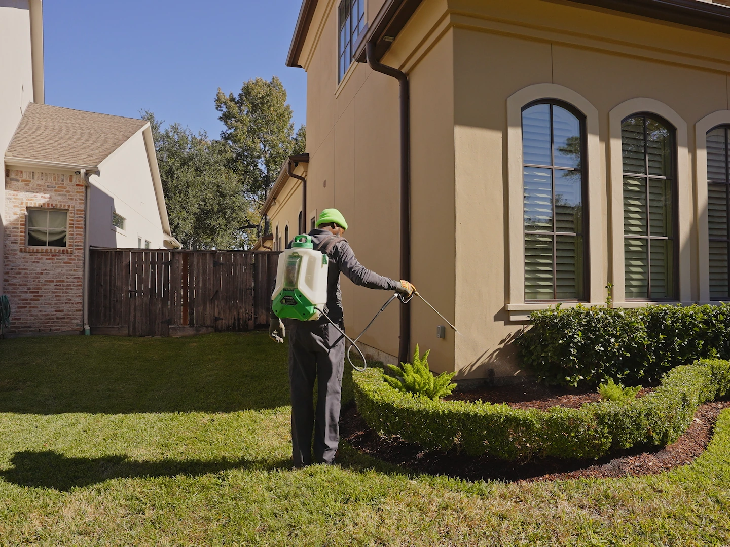 A technician treating the foundation line of a San Antonio home